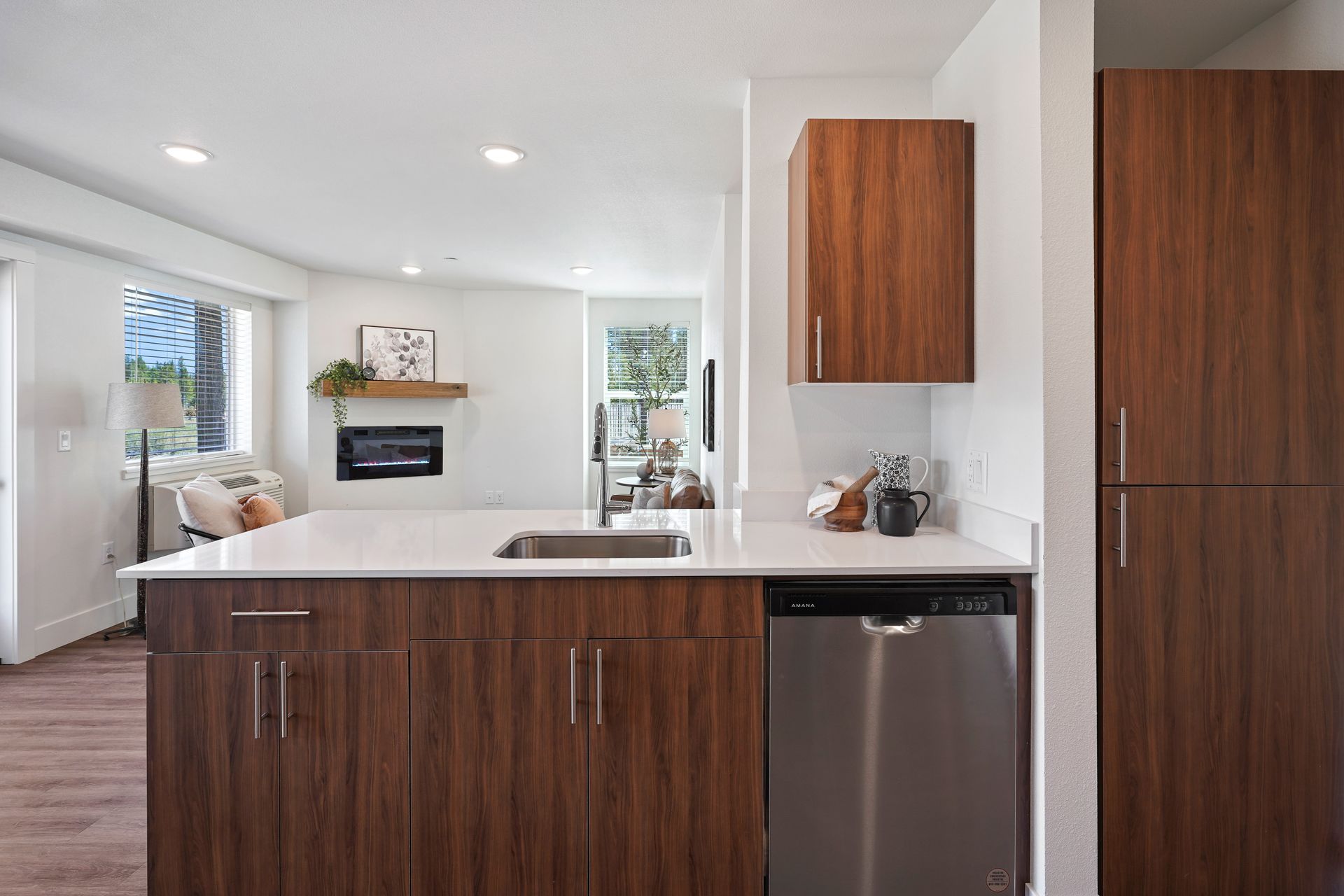 A kitchen with stainless steel appliances and wooden cabinets.