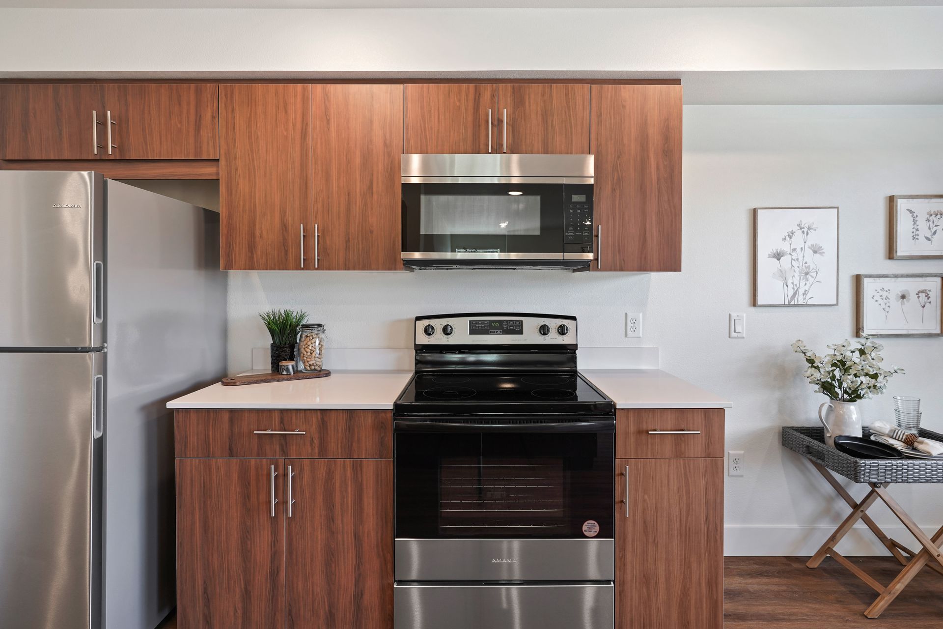 A kitchen with stainless steel appliances and wooden cabinets.