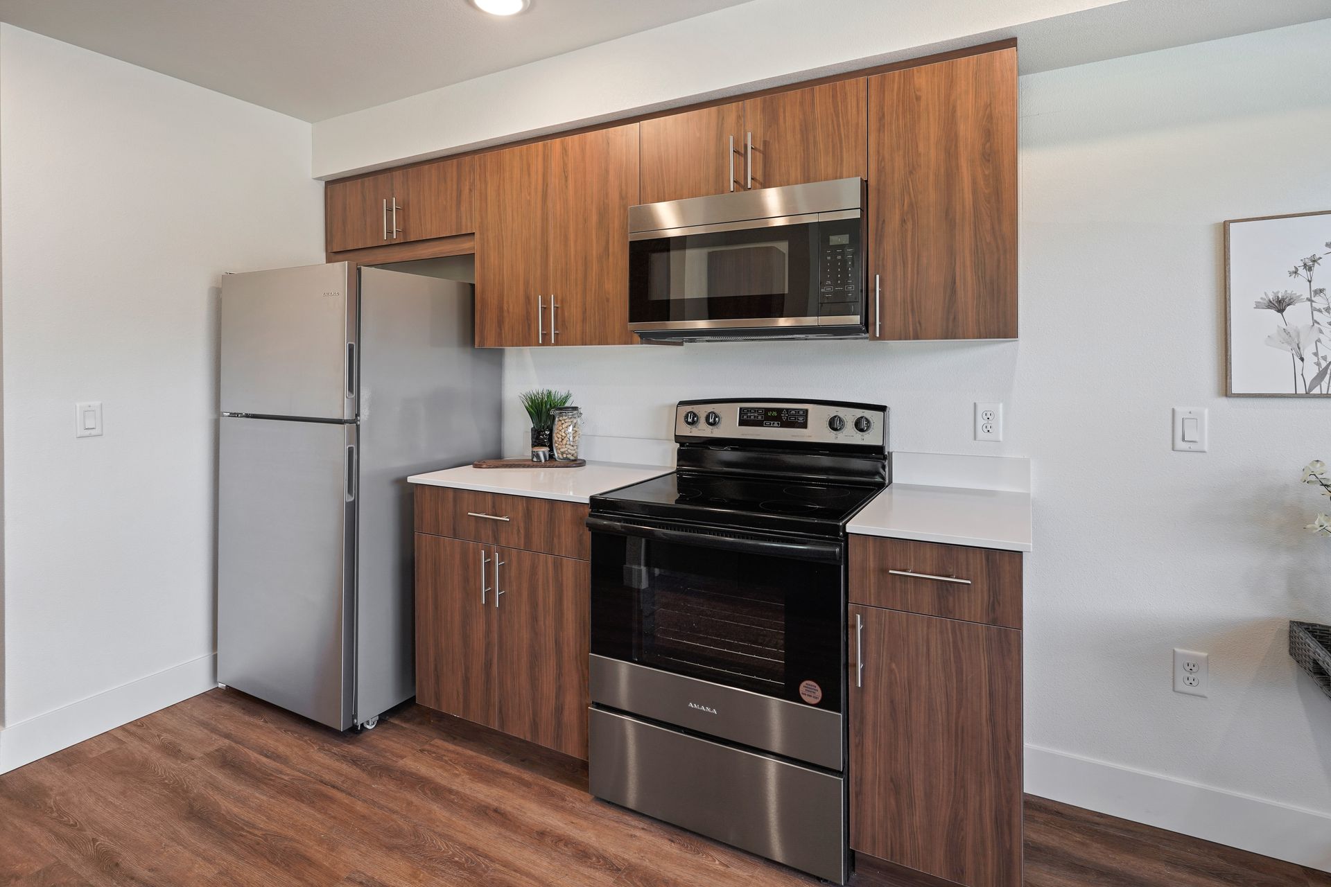 A kitchen with stainless steel appliances and wooden cabinets
