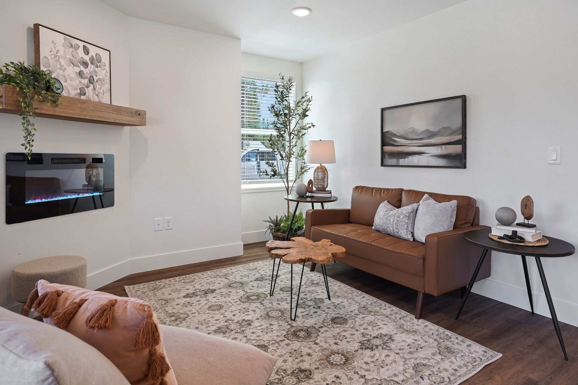 A living room with a couch , fireplace , table and rug.