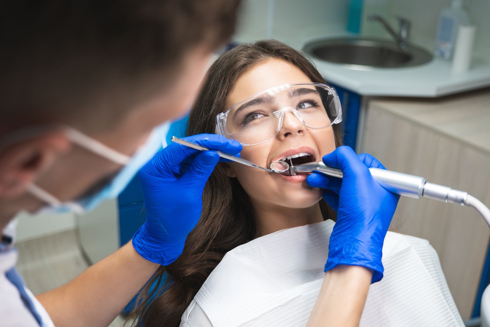 A woman is getting a root canal.