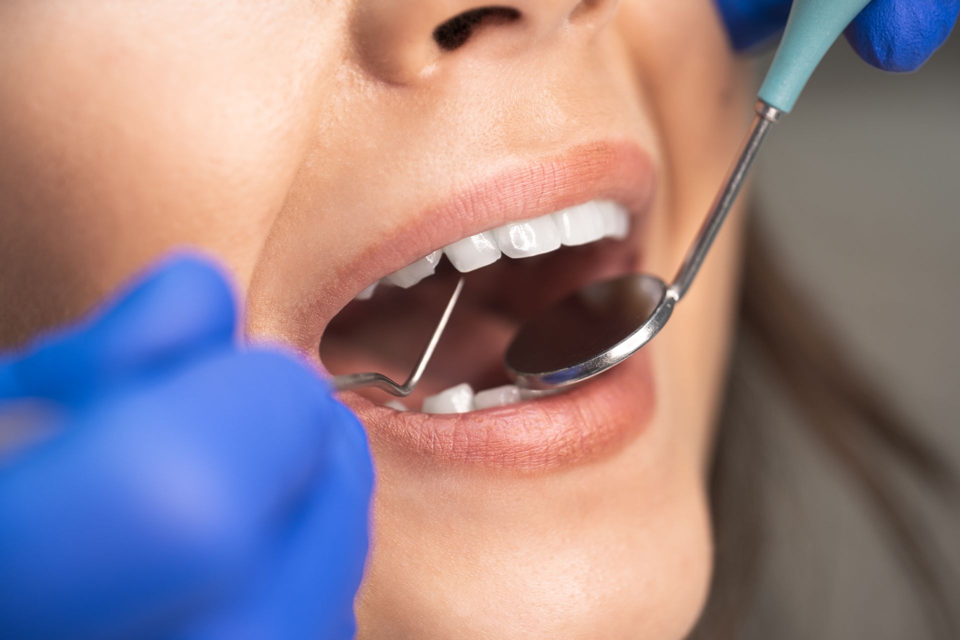 A dental professional inspecting a tooth for a root canal. A dental professional inspecting a tooth for a root canal.