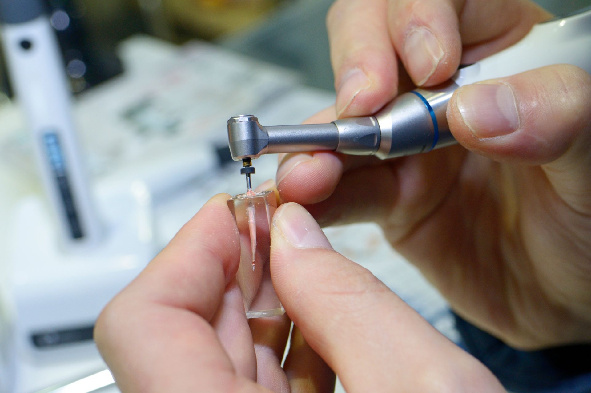 Dentist preparing dental equipment for a root canal procedure.