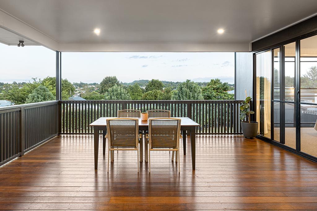 a large wooden deck with a table and chairs on it .