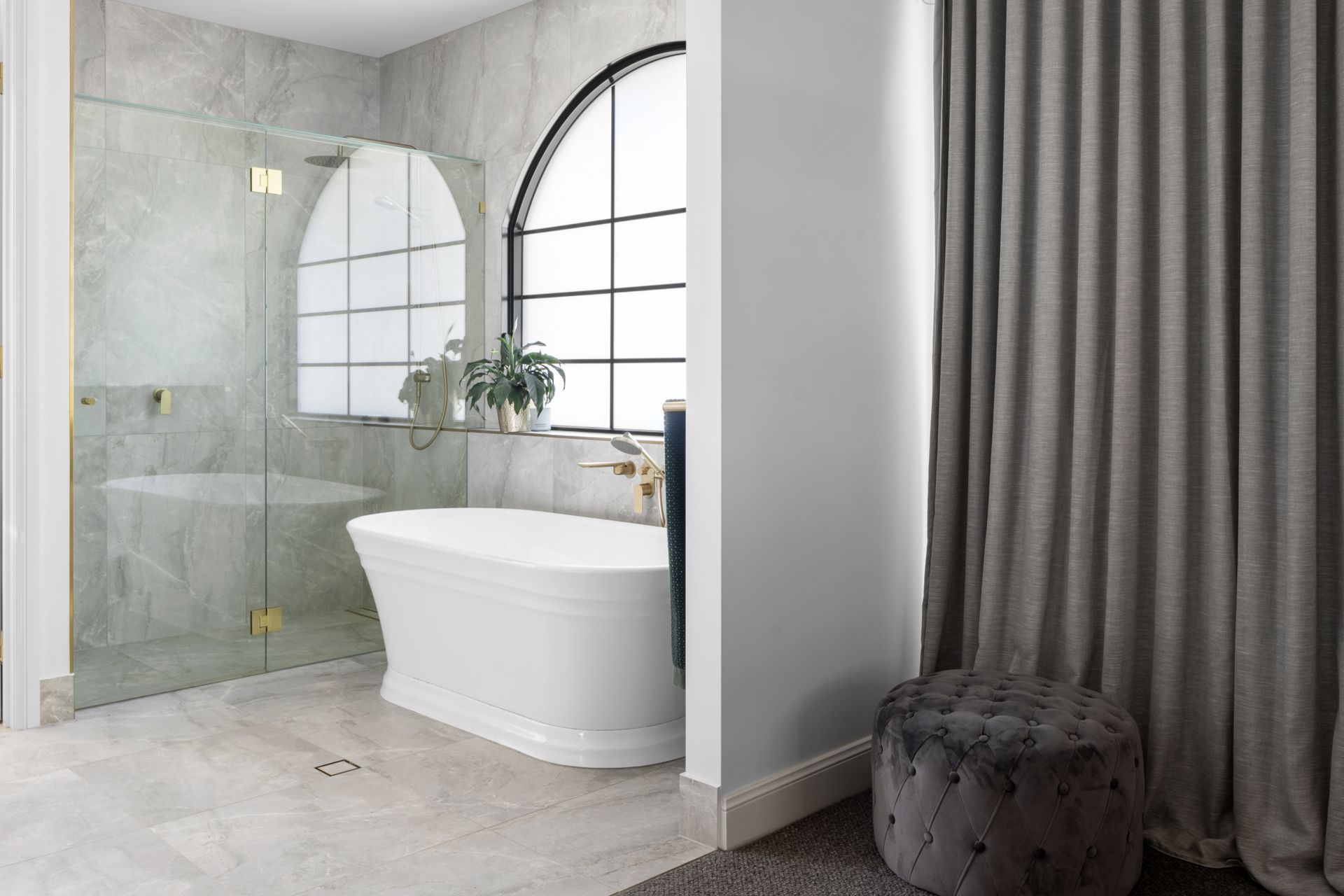 a bathroom with a bathtub and a walk in shower .
