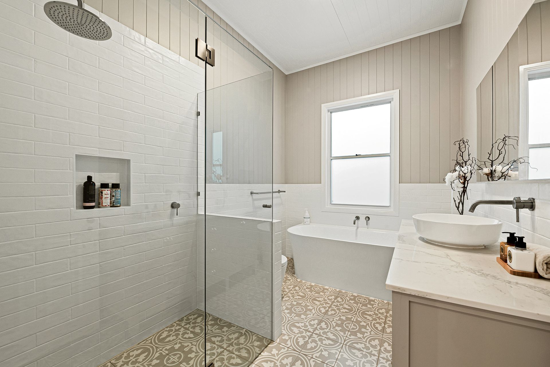 a bathroom with a walk in shower , bathtub , sink and mirror .
