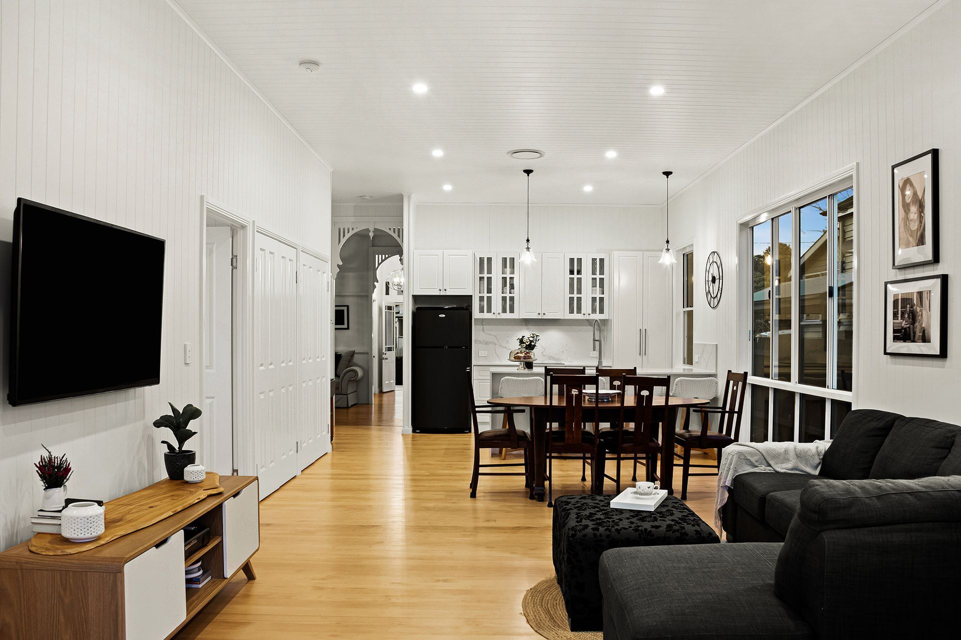 a living room filled with furniture and a flat screen tv .