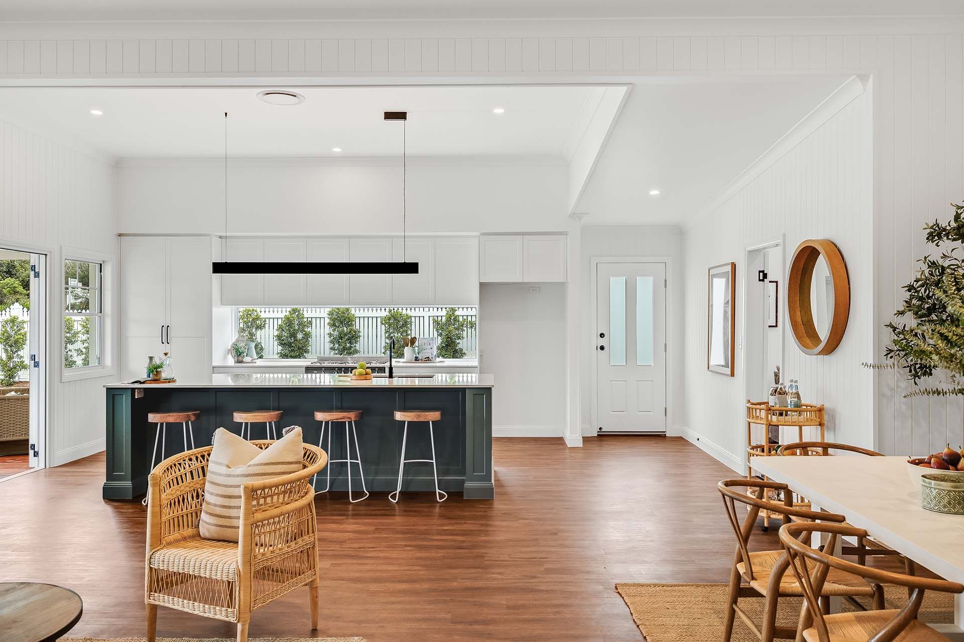 a living room with a table and chairs and a kitchen .