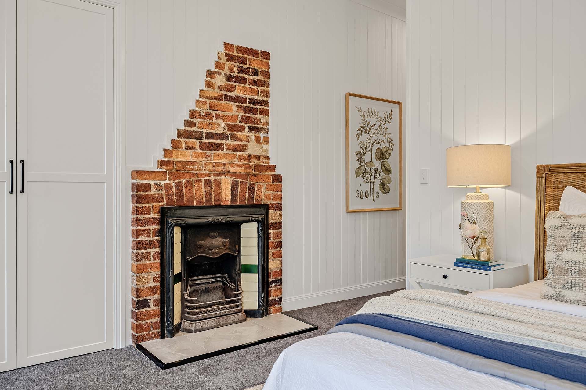 a bedroom with a brick fireplace and a bed .