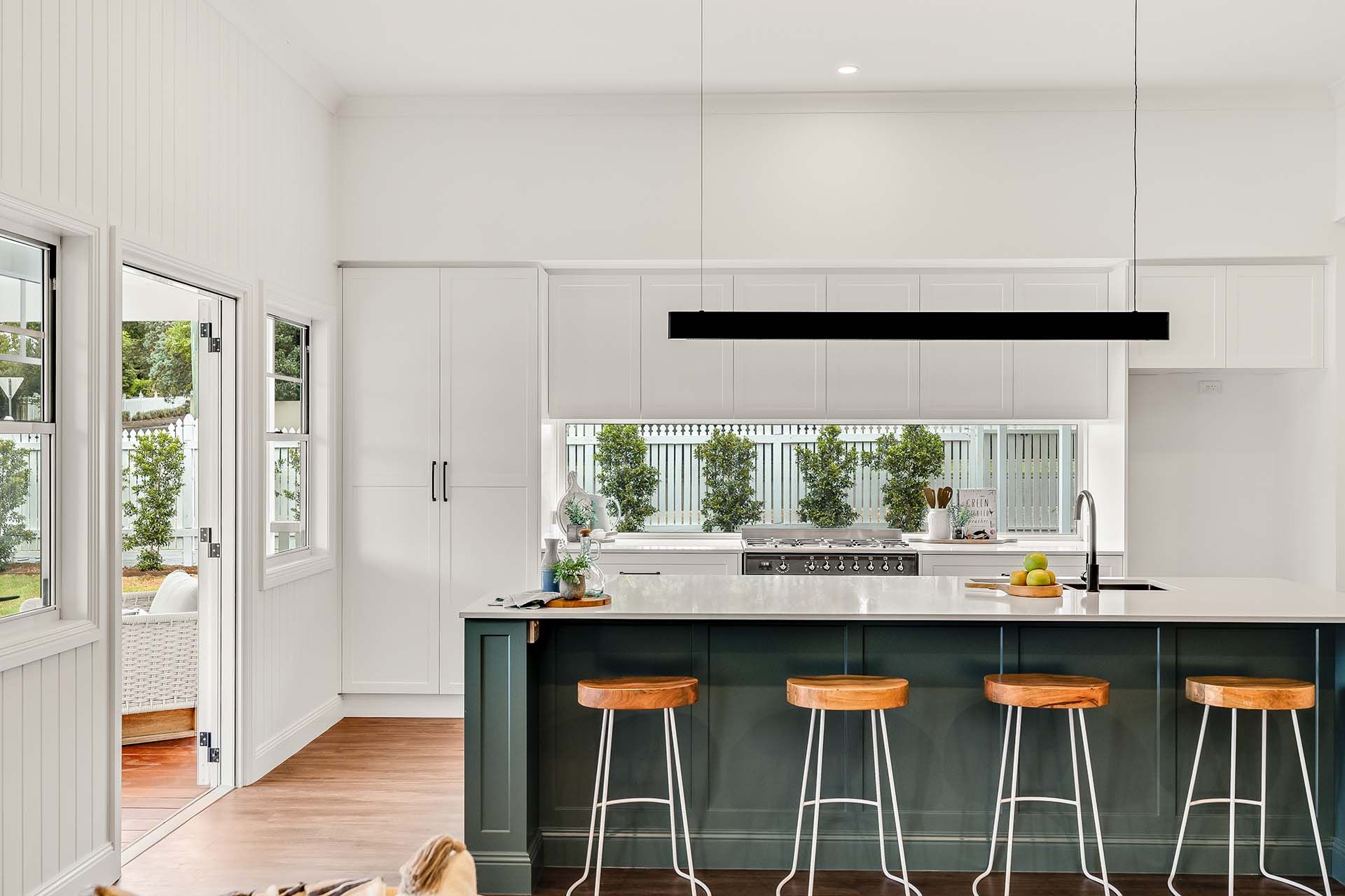 a kitchen with a large island and stools