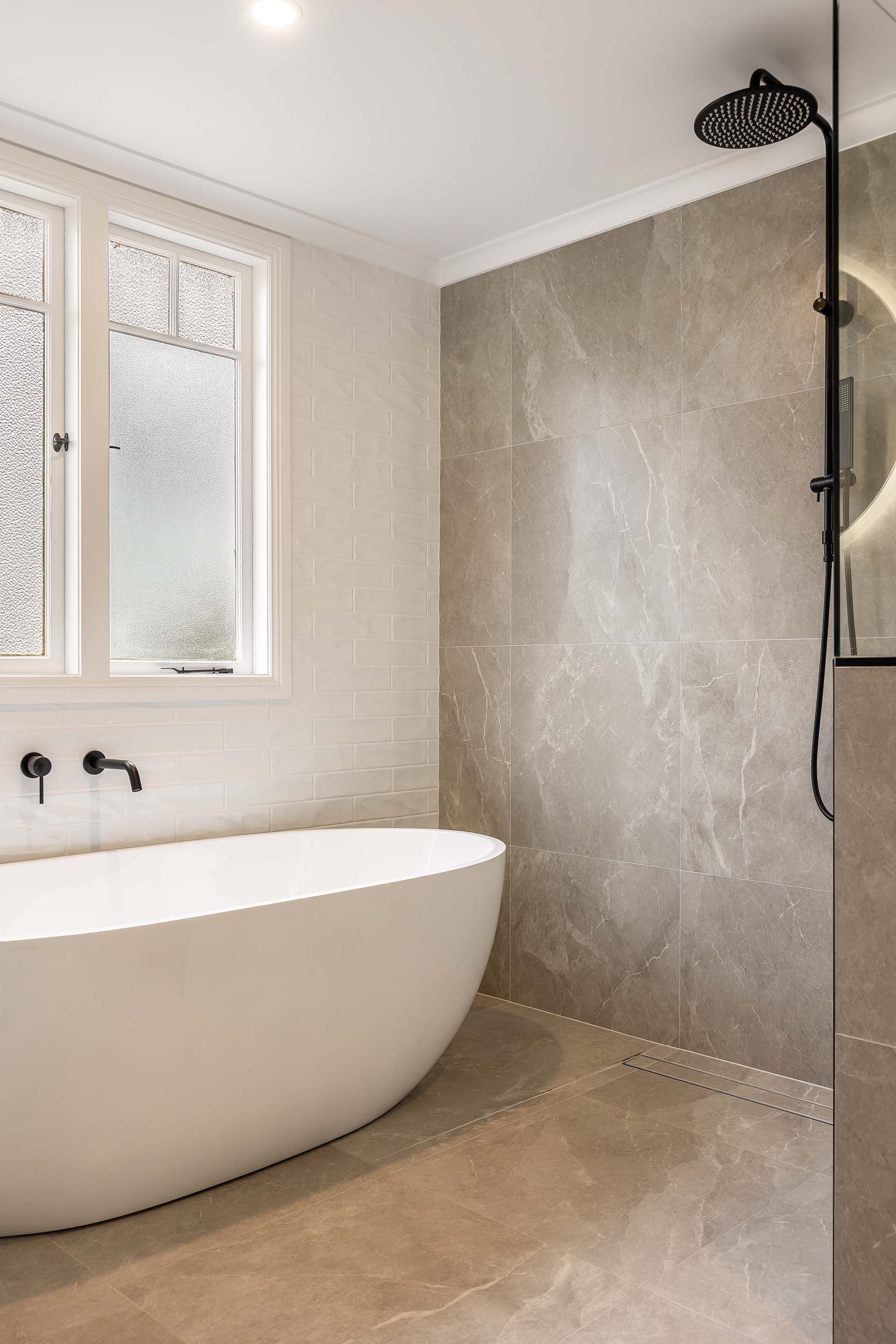 a bathroom with a bathtub and a shower .