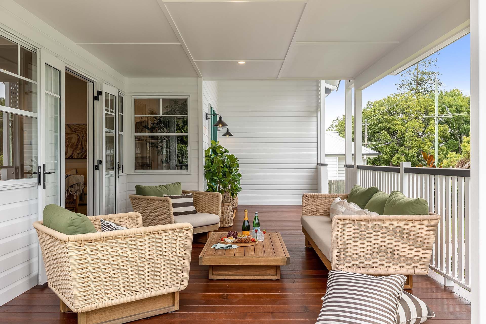 a veranda with wicker furniture and a coffee table .