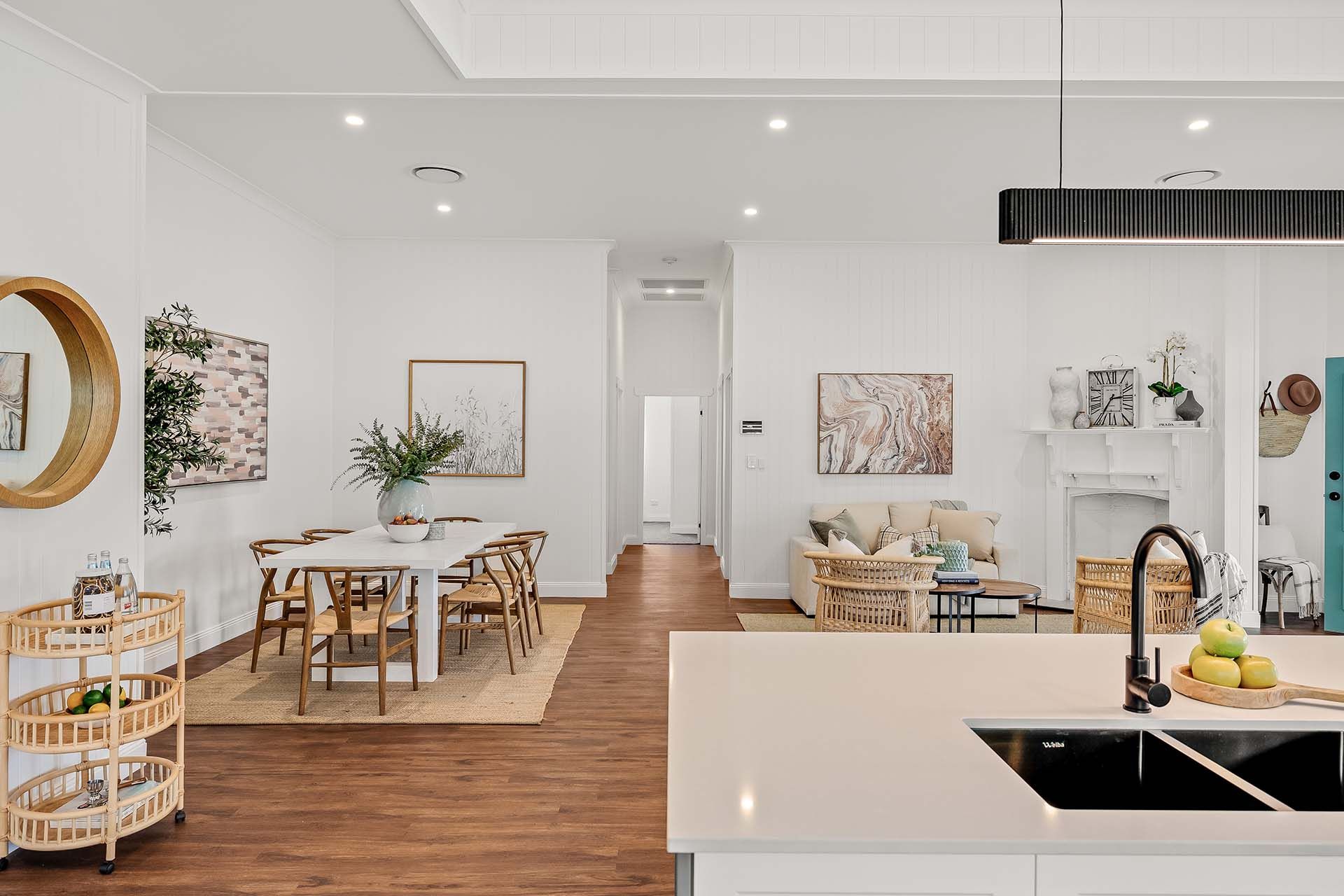 a kitchen with a sink , dining table and chairs .