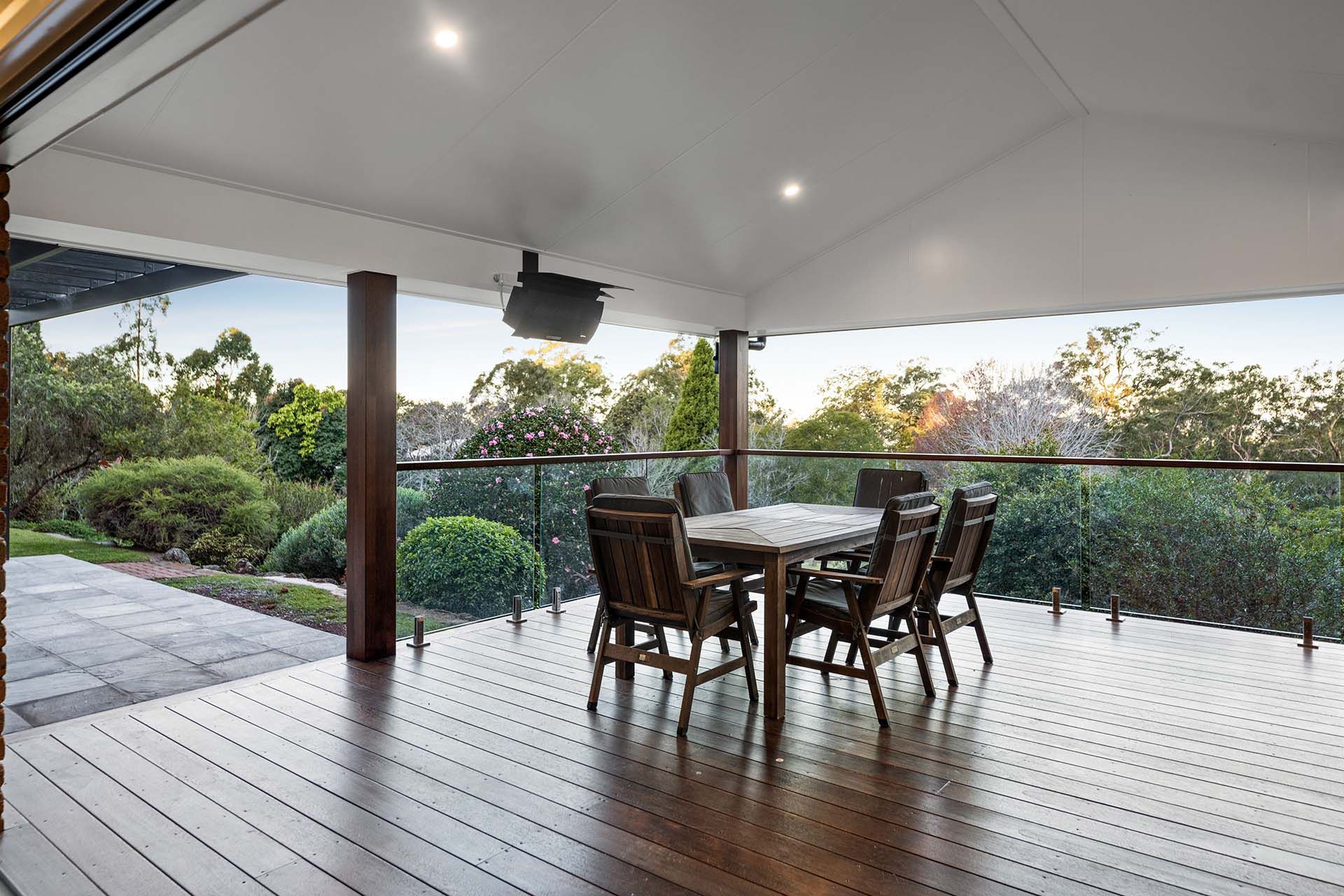 a wooden deck with a table and chairs on it