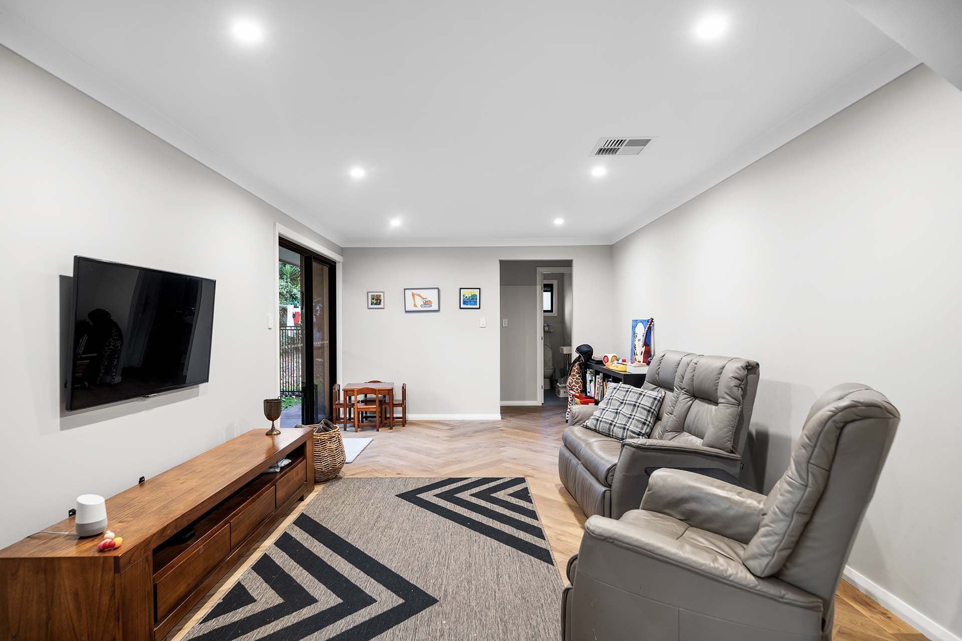 a living room filled with furniture and a flat screen tv .