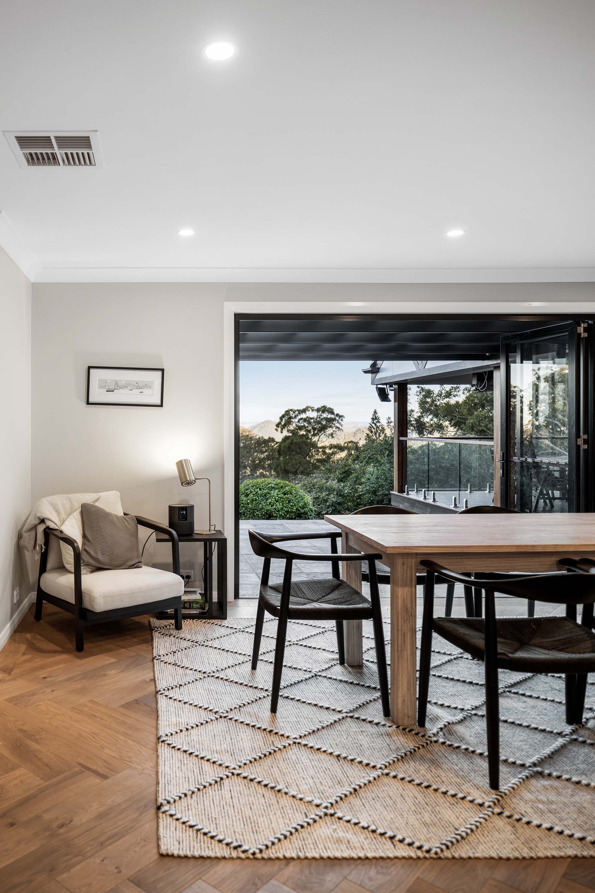 a dining room with a table and chairs and a rug .