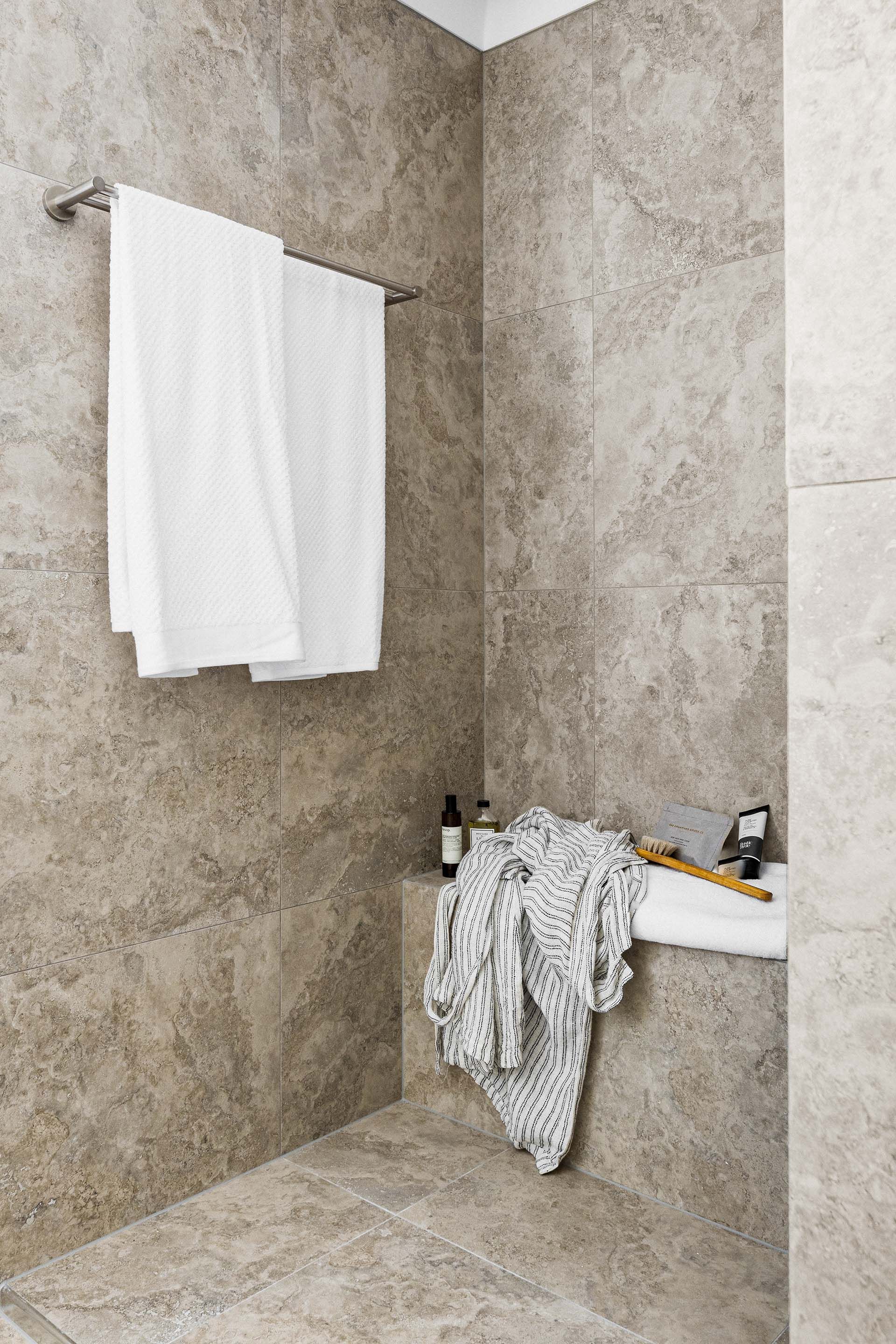 a bathroom with a bathtub and a towel hanging on the wall .