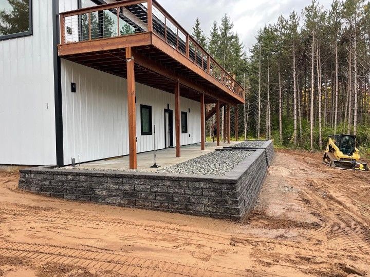 House with a Wooden Deck and a Brick Wall — Eau Claire, WI — Gold Landscaping