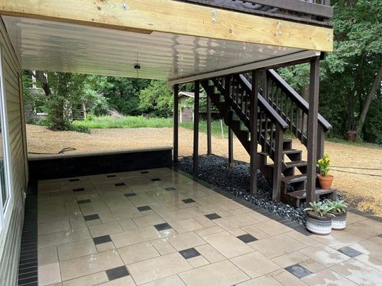 Patio Under a Deck of a House — Eau Claire, WI — Gold Landscaping