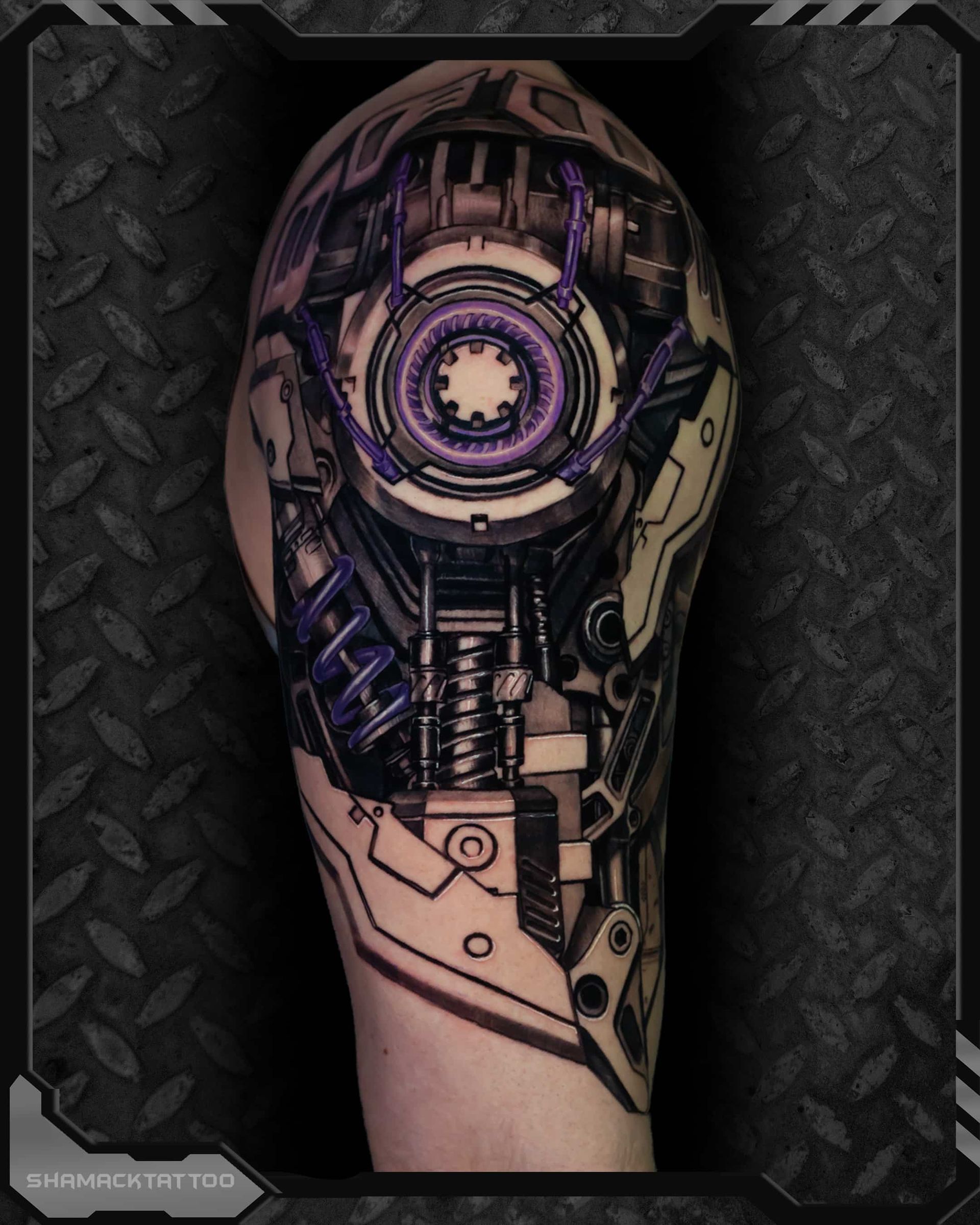 Detailed cyberpunk-style tattoo of a mechanical eye and circuitry on a forearm, with purple and beige tones.