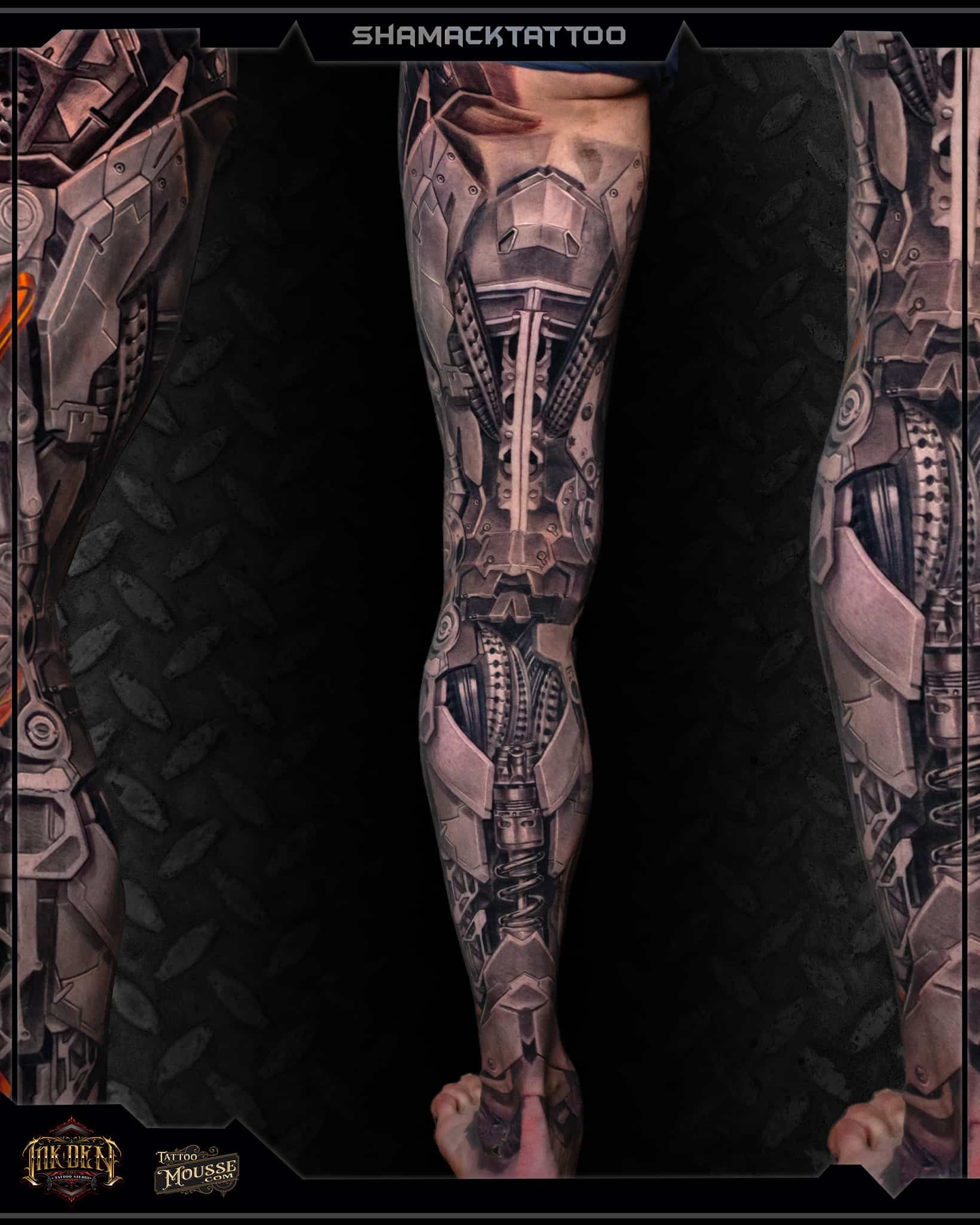 Full-leg black and gray biomechanical tattoo design on a person’s lower leg and foot