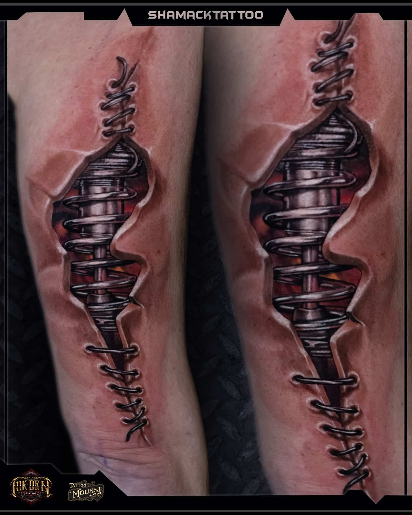 Close-up of two tattooed forearms with matching metallic spiral spine designs against pink skin