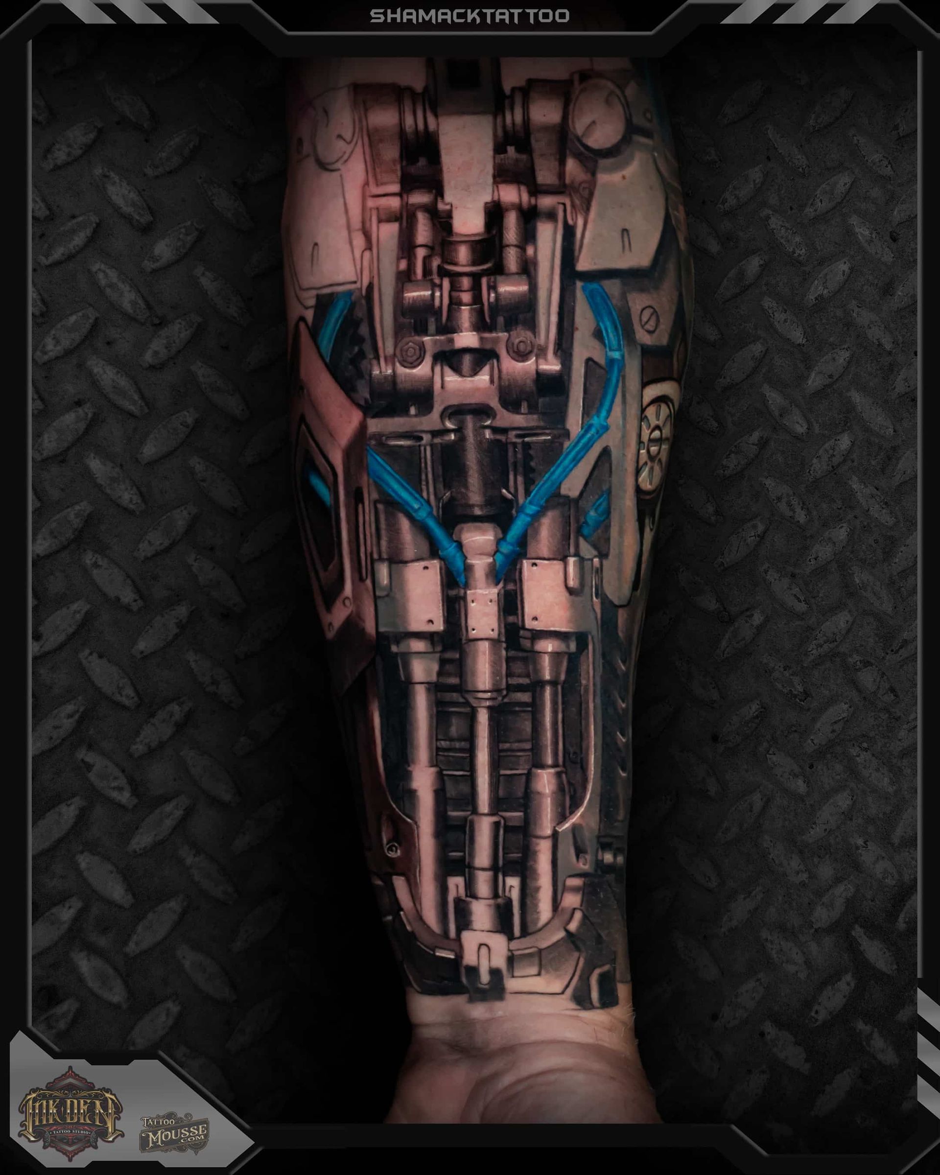 Close-up of a mechanical cybernetic leg with exposed pistons, blue cables, and a dark industrial frame