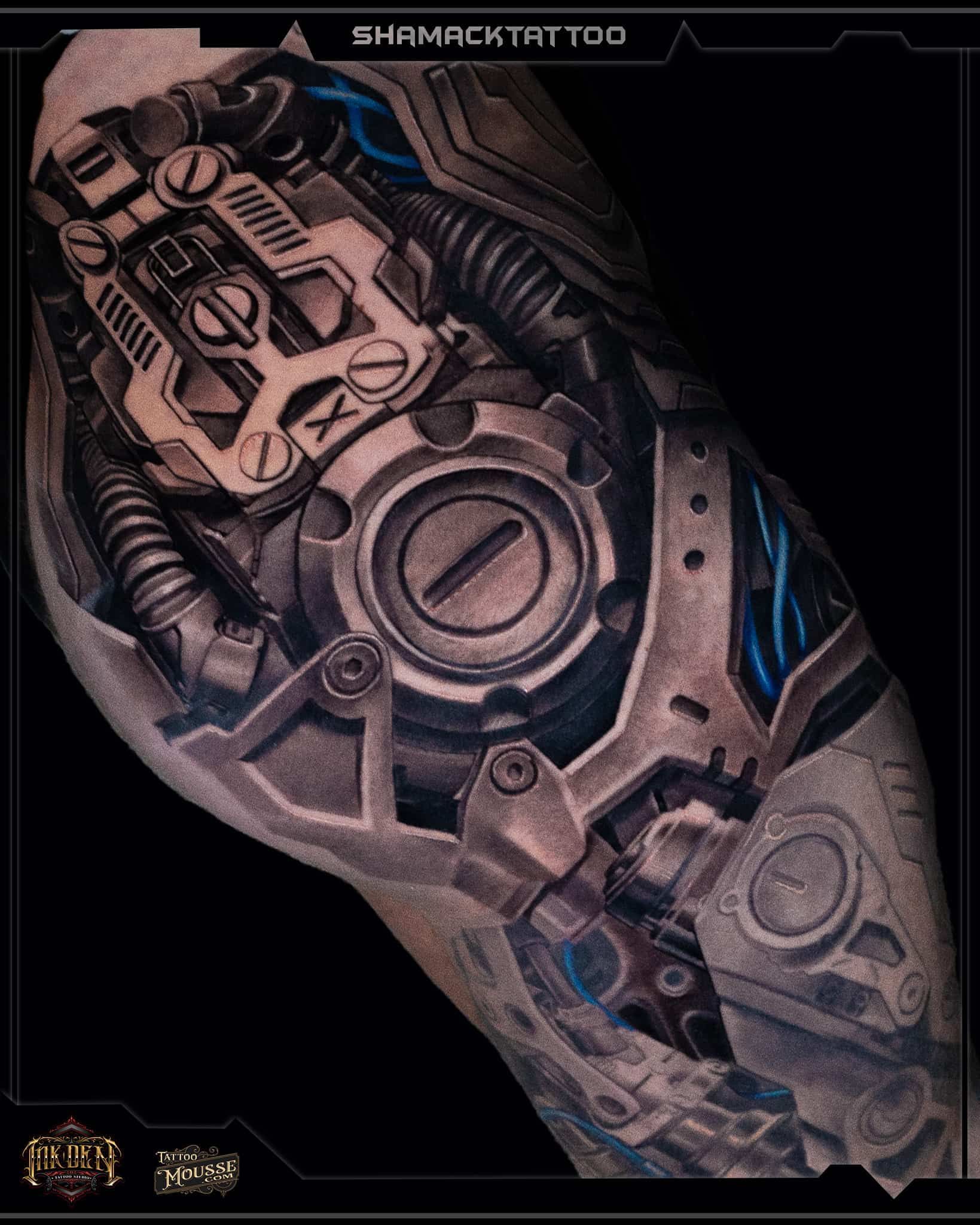 Futuristic armored forearm with circular mechanical details, shown in bronze, gray, and blue on a dark background
