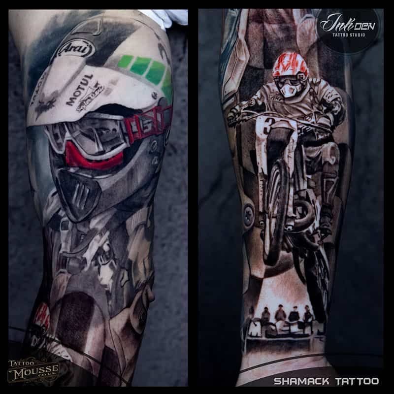 Tribal-style motorcycle tattoo sleeve, showing a rider in a helmet and an off-road bike in black, gray, and red.