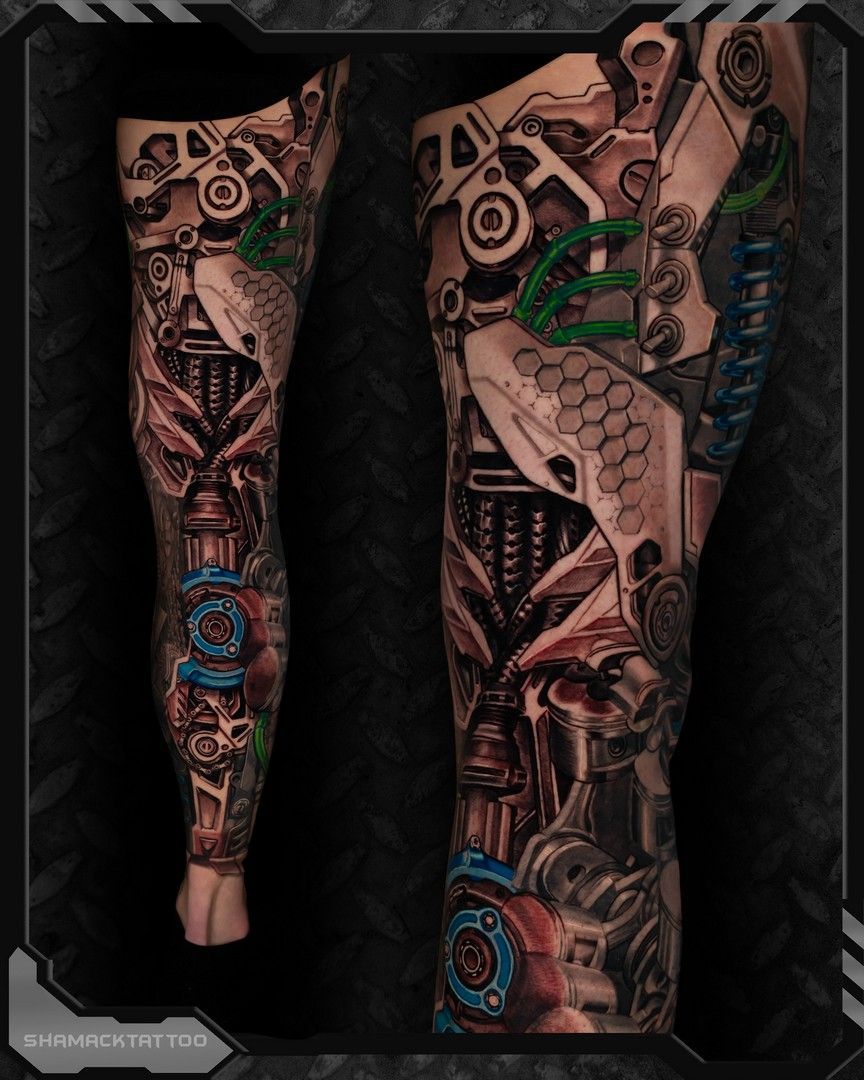 Legs with dark steampunk-style tattoo sleeve artwork in brown, black, teal, and green tones.