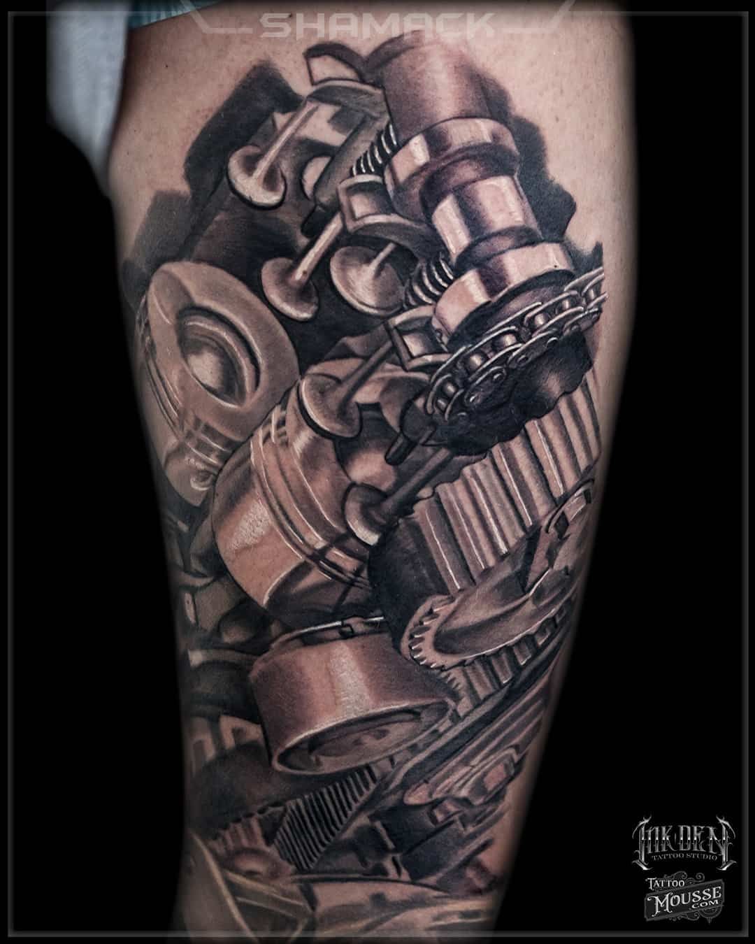 Black-and-gray sleeve tattoo of mechanical gears, pipes, and an industrial valve on an arm