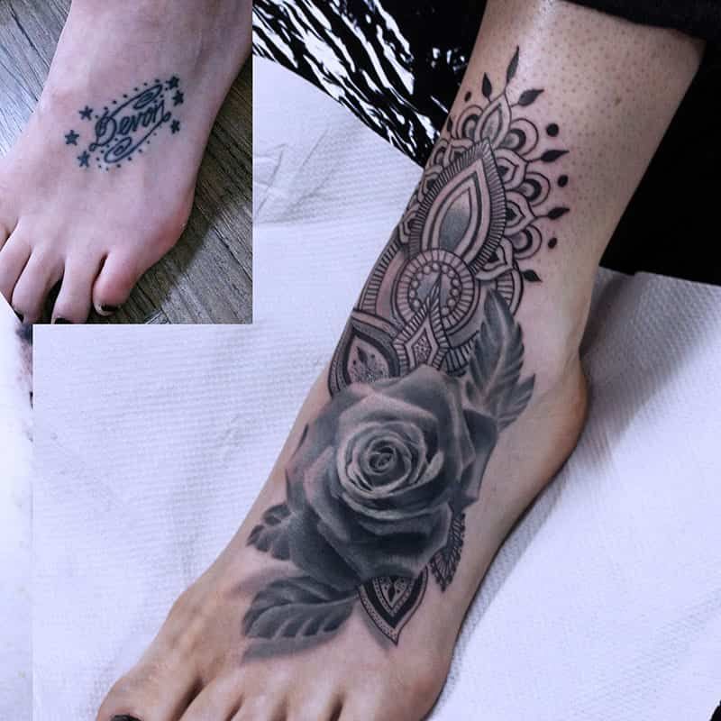 Tattooed foot and ankle with a large black-and-gray rose and mandala design, plus a small inset foot tattoo