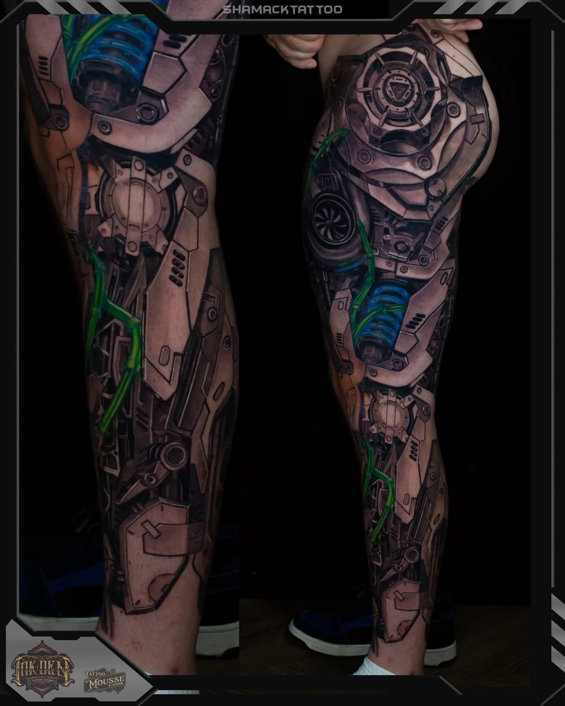 Tattooed legs with intricate black and blue biomechanical designs, shown front and back on a dark background