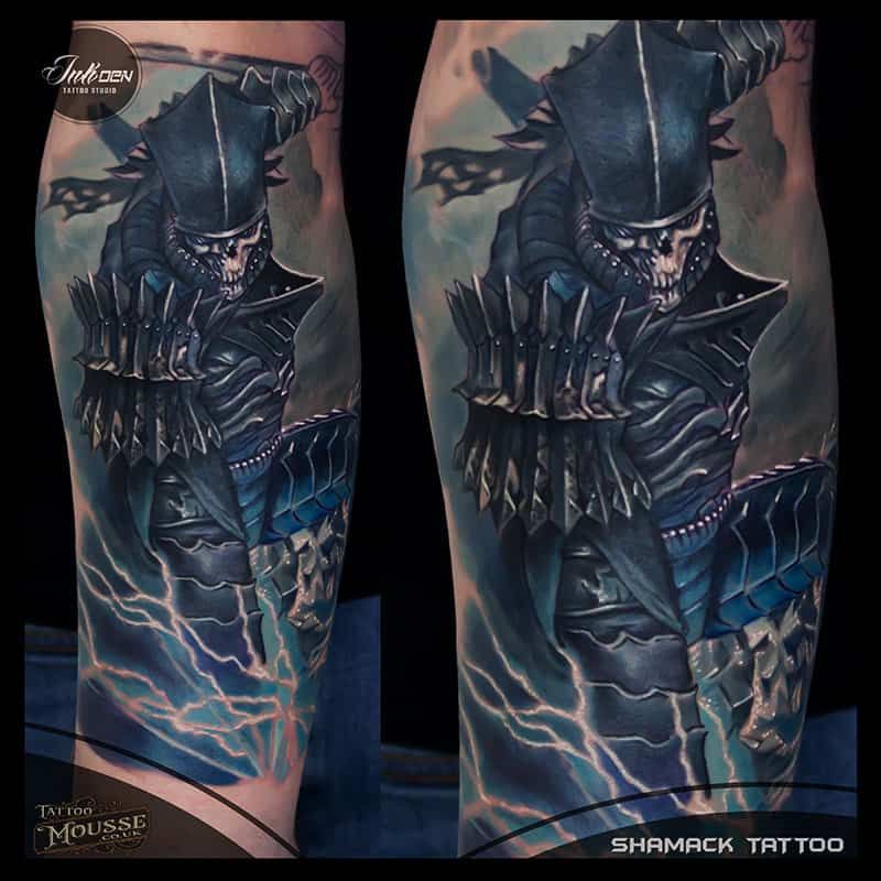 Side-by-side leg tattoos of a dark armored character with blue lightning on a black background