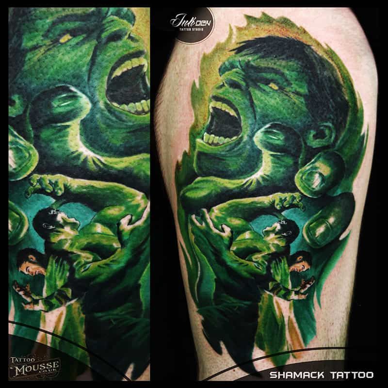 Green Hulk-themed tattoo design on a leg, with a large roaring face and smoky green effects