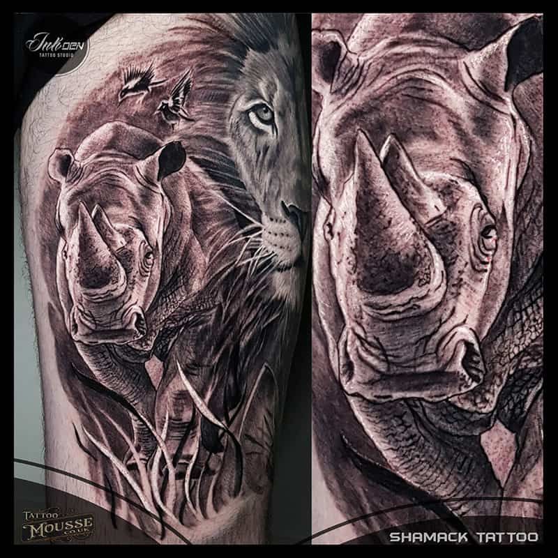 Two-panel black and gray tattoo art of a lion and rhinoceros facing forward, highly detailed and shaded