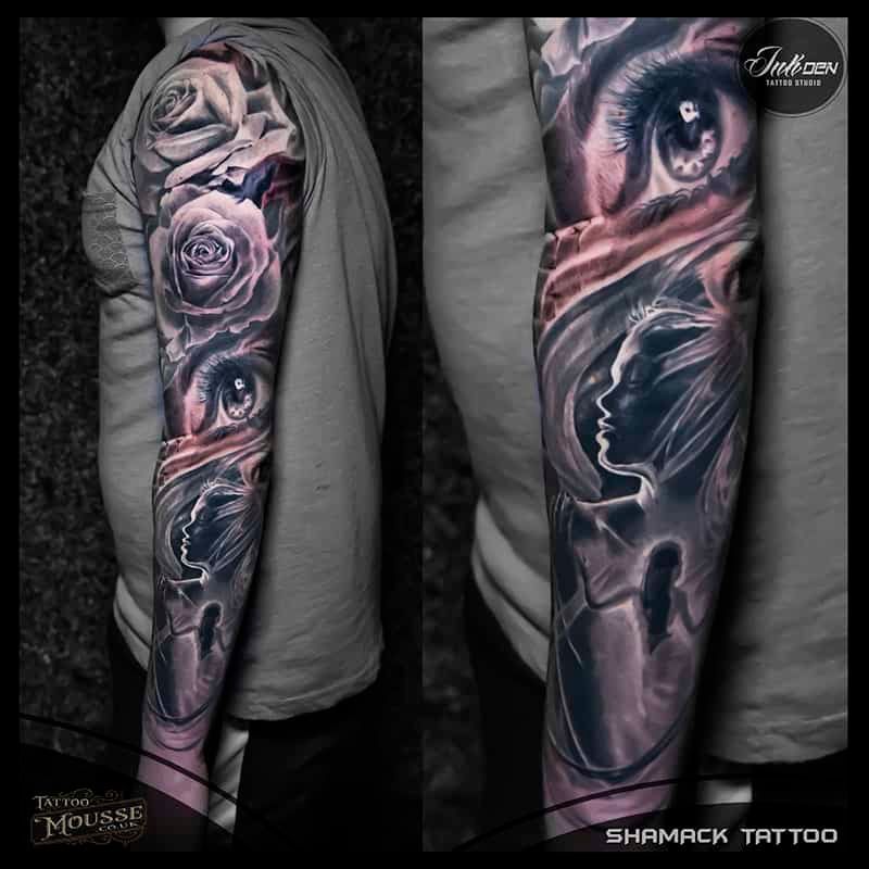 Two side-by-side arm tattoos with surreal faces, roses, and dark smoky shading on a gray sleeve.