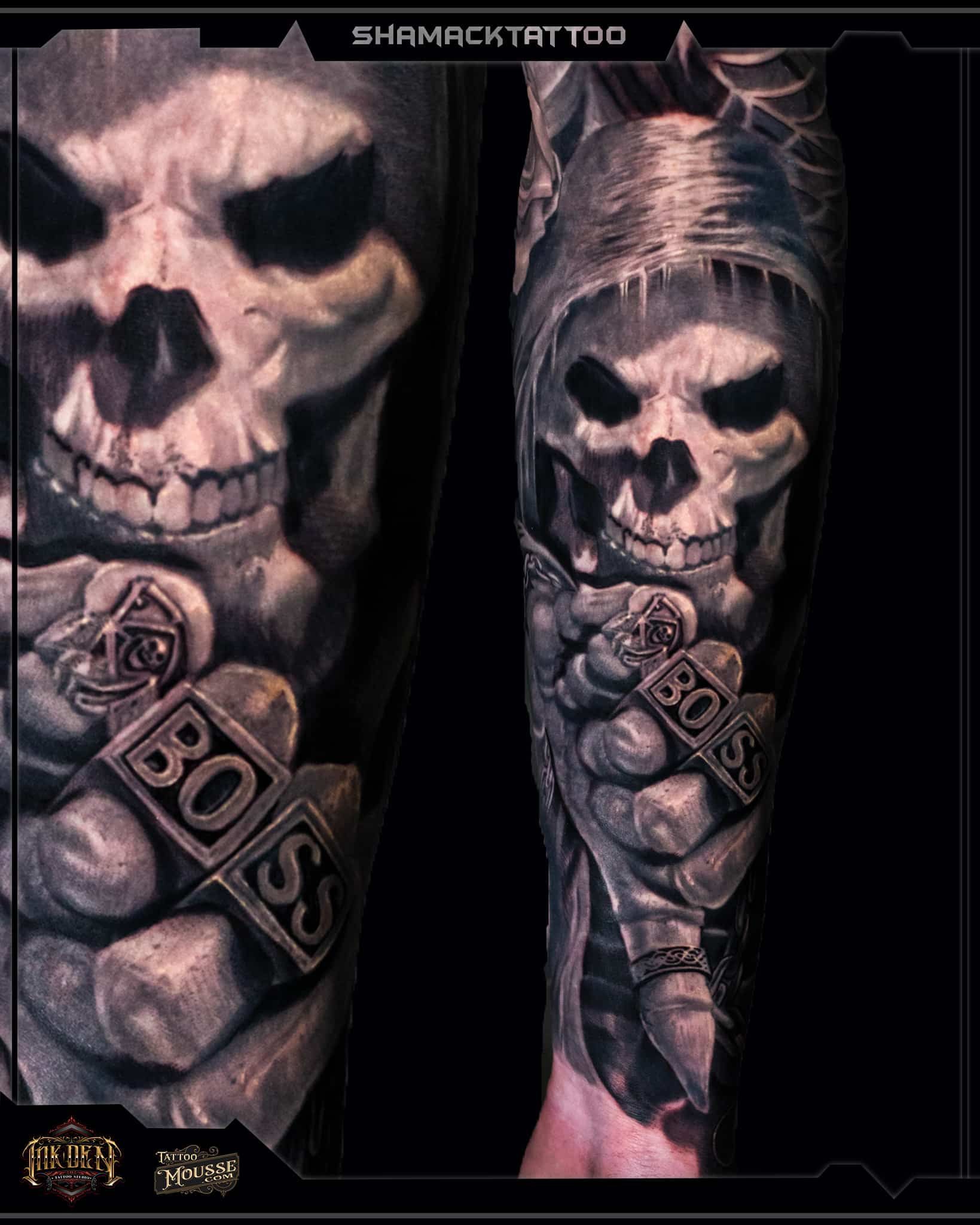 Skull tattoo on forearm with bold “BOIS” lettering, dark shading, and pink accents