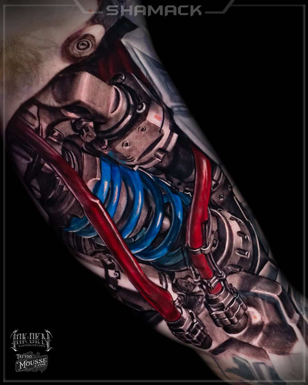 Stylized cybernetic humanoid torso with red cables and blue coil on dark background