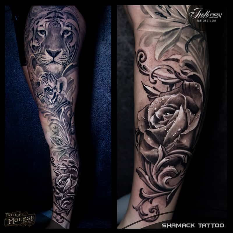 Two black-and-gray tattoo sleeves: a tiger and floral design on one arm, roses and swirls on the other.
