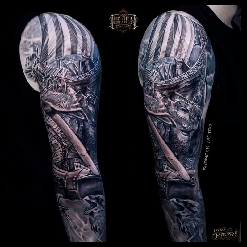 Black-and-gray sleeve tattoo design showing a surreal figure in a striped cap on both arms.