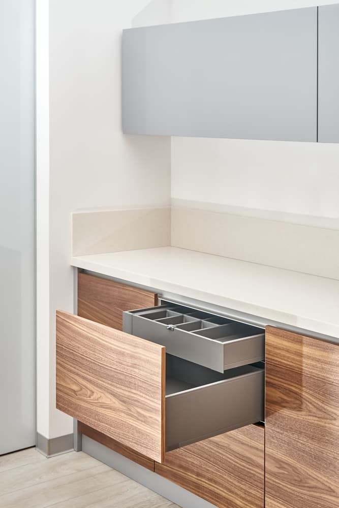 A Kitchen With Wooden Cabinets and a Stainless Steel Drawer Open — PKJ Designs in Unanderra, NSW