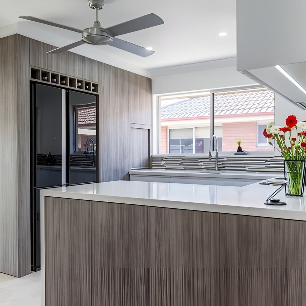 A Kitchen With Stools and a Clock on the Wall — PKJ Designs in Unanderra, NSW