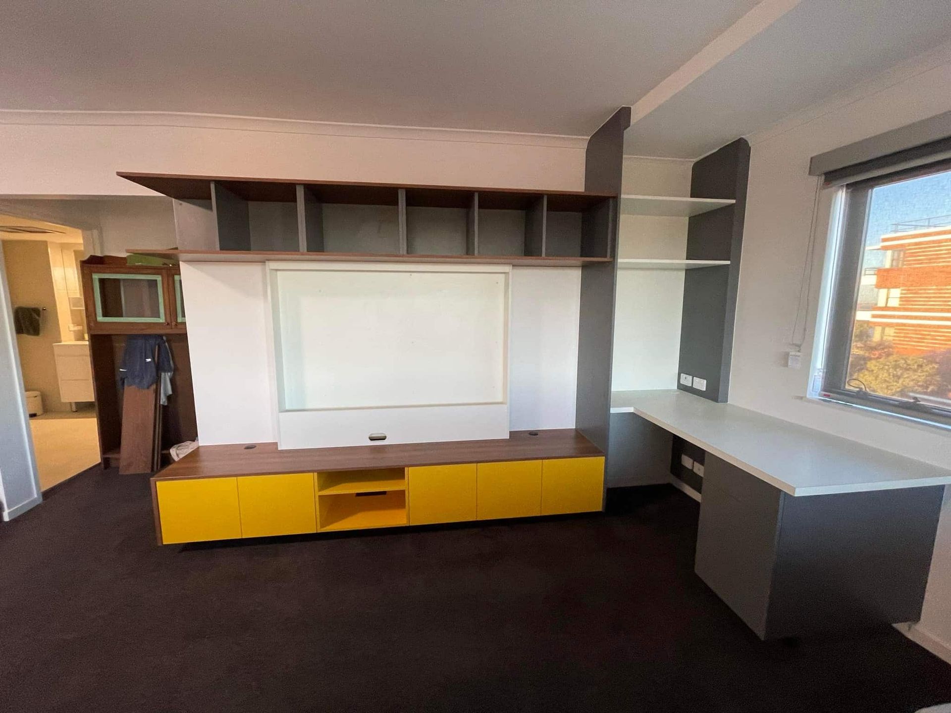 A Living Room With a Yellow Entertainment Center — PKJ Designs in Unanderra, NSW