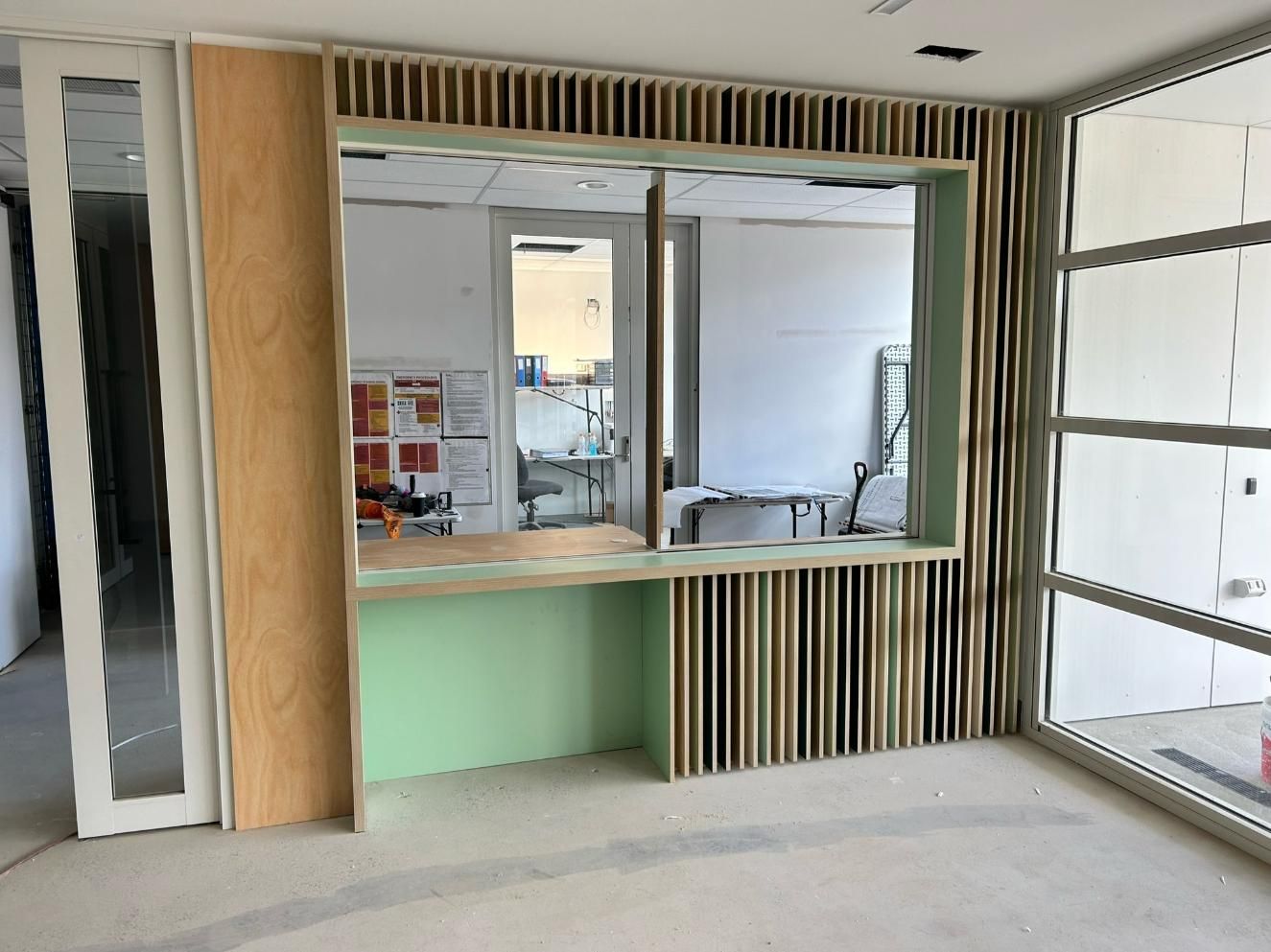 A Large Empty Room With Hardwood Floors and White Cabinets — PKJ Designs in Dapto, NSW