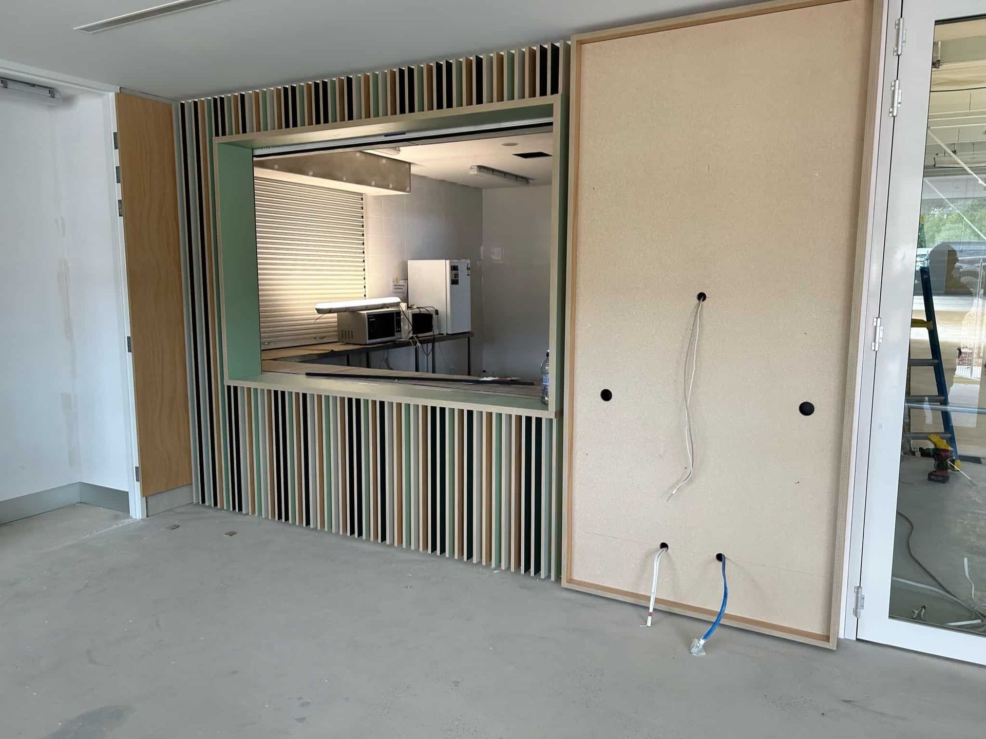An Empty Room With a Striped Wall and a Window — PKJ Designs in Unanderra, NSW