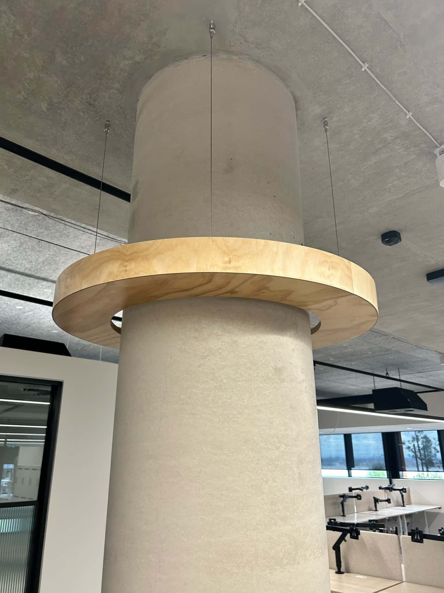 A Pillar With a Wooden Circle on Top of It in an Office — PKJ Designs in Unanderra, NSW