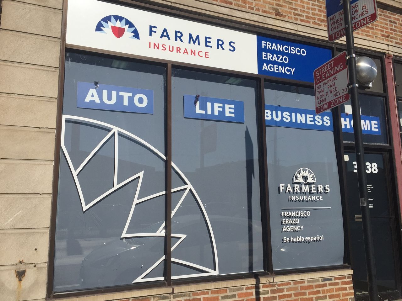 Farmers Insurance storefront with blue signs for auto, life, business, and home services