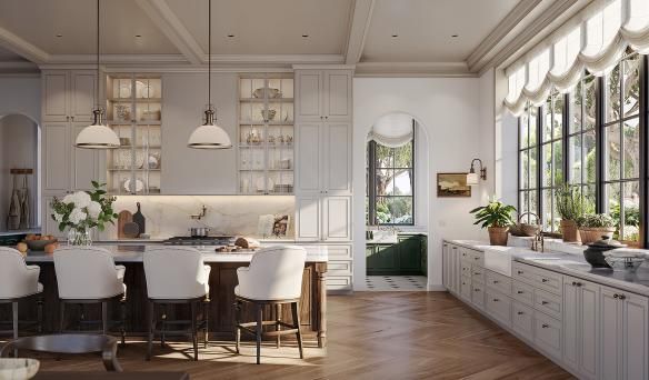 Bright modern kitchen with white cabinetry, island seating, and large windows overlooking greenery