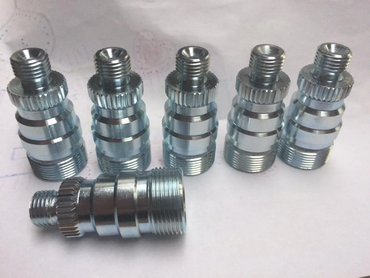 Five silver metal threaded fittings arranged on a white background.